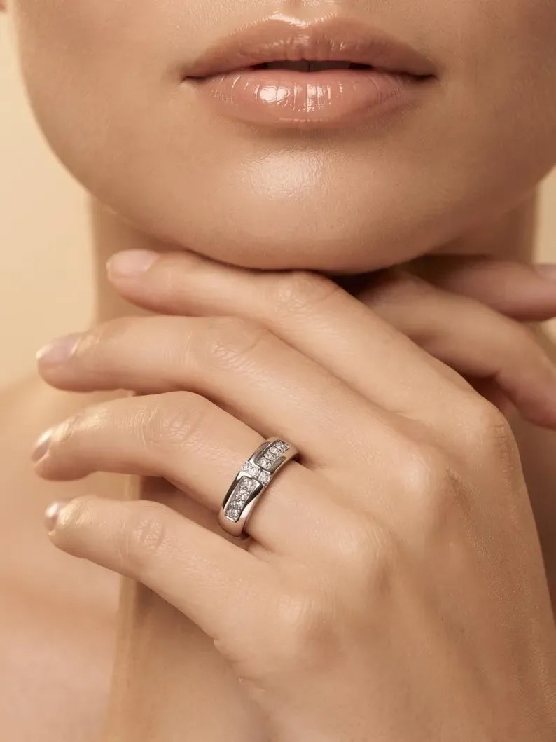 Close-up of a 925 sterling silver band ring with three rectangular CZ channel-set panels, worn on the hand