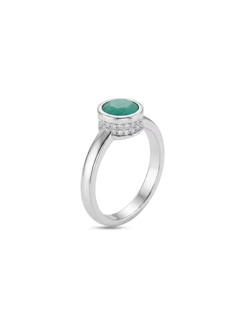 925 sterling silver ring with a round green stone in a bezel setting and small CZ accents