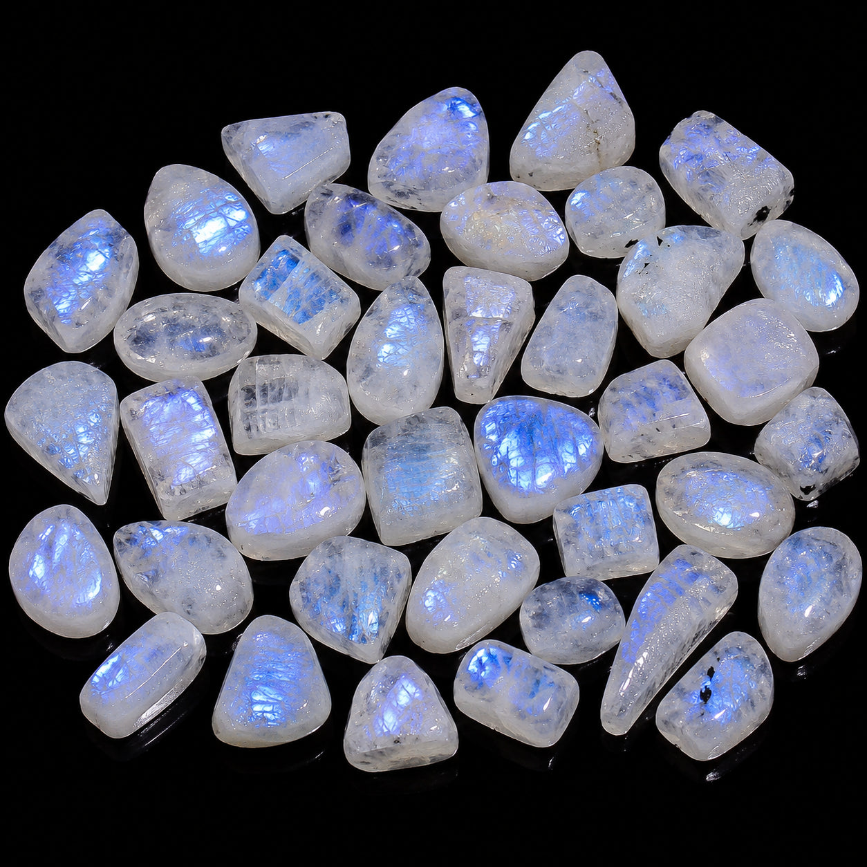 Collection of raw moonstone crystals on a black background