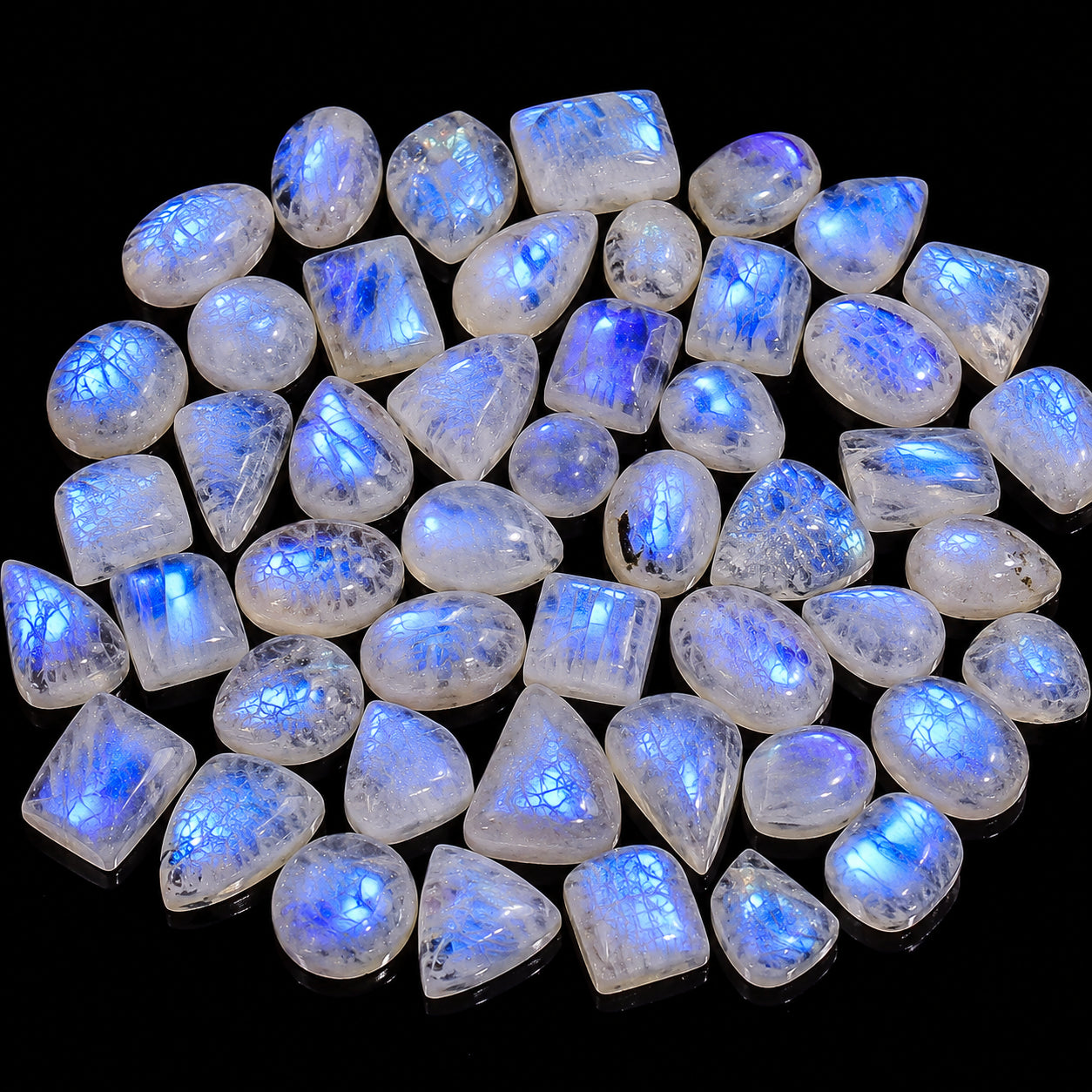 Collection of blue-fluorescent gemstones on a black background