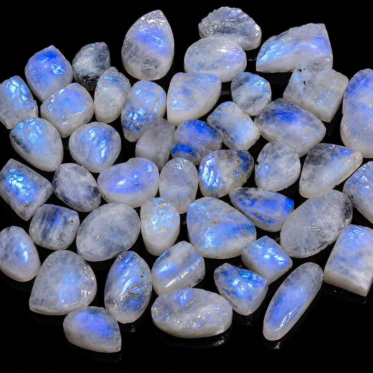Collection of blue-fluorescent stones on a black background