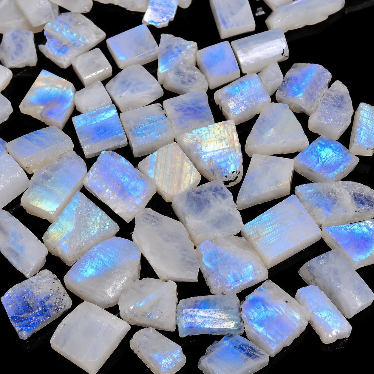 Close-up of rainbow moonstone gemstones on a black background