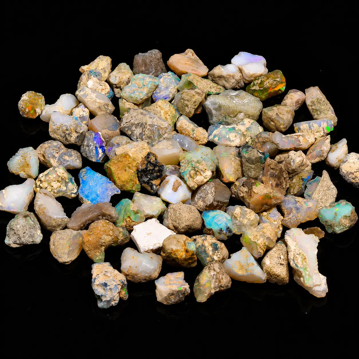 Collection of small, multicolored gemstones on a black background