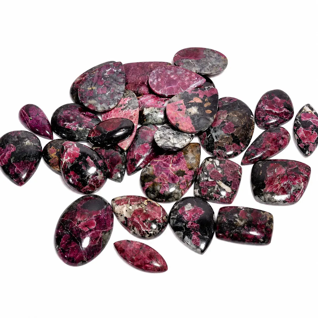 Collection of pink and black marbled stones on a white background