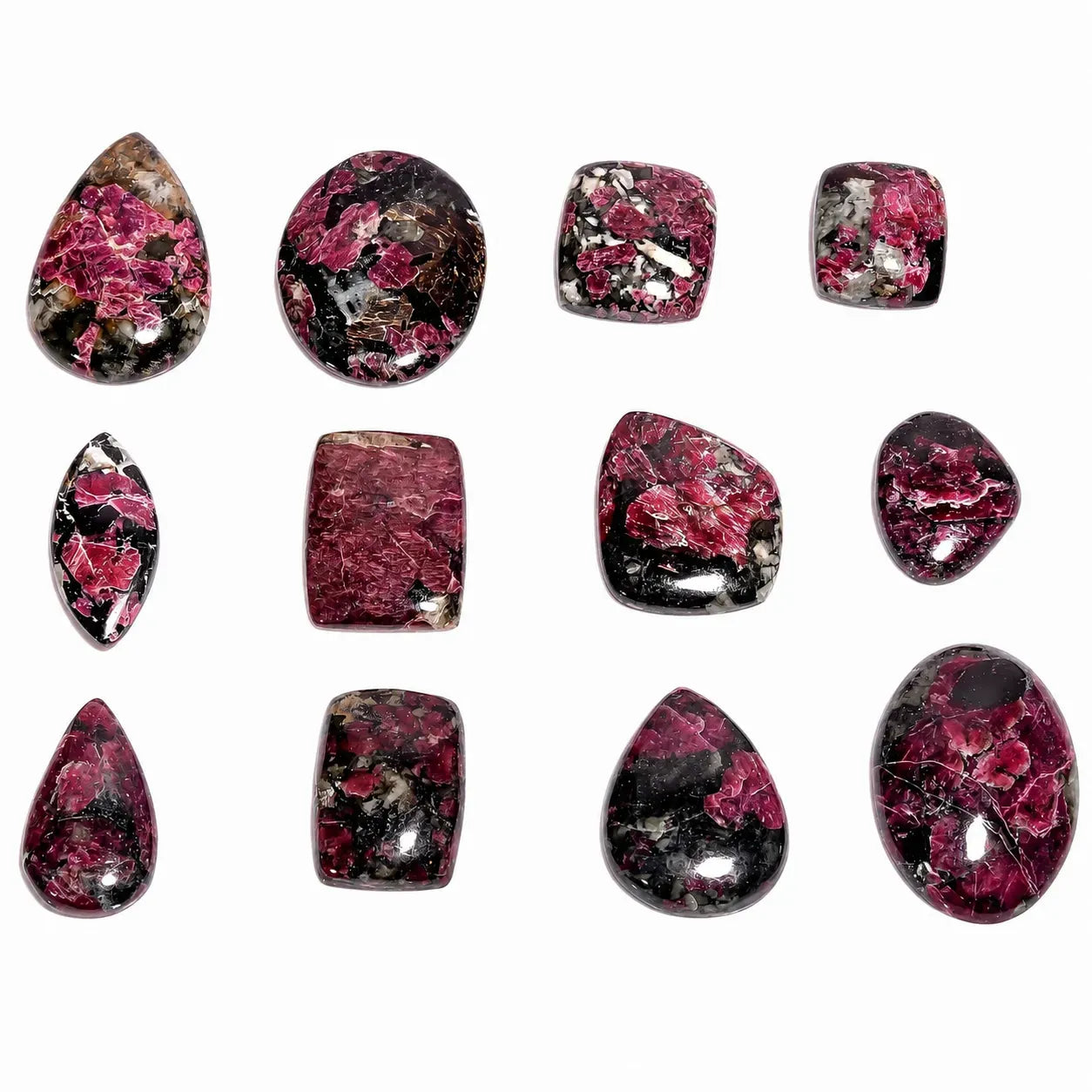 Collection of pink and black marbled stones on a white background