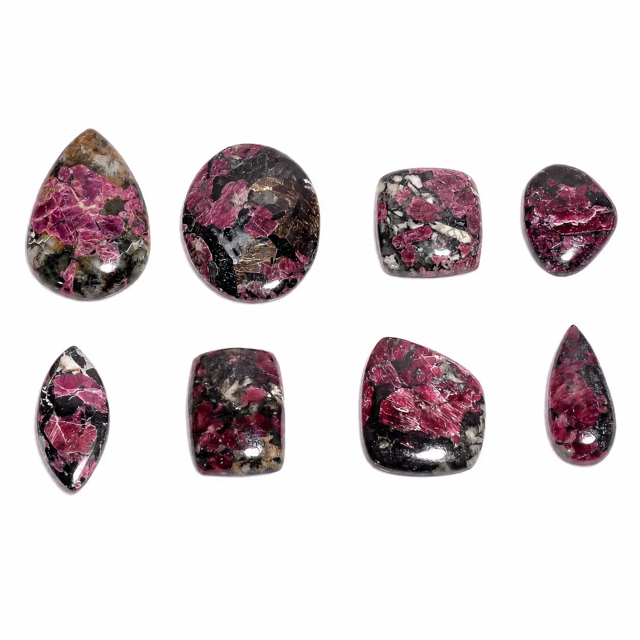 Set of pink and black marbled stones on a white background