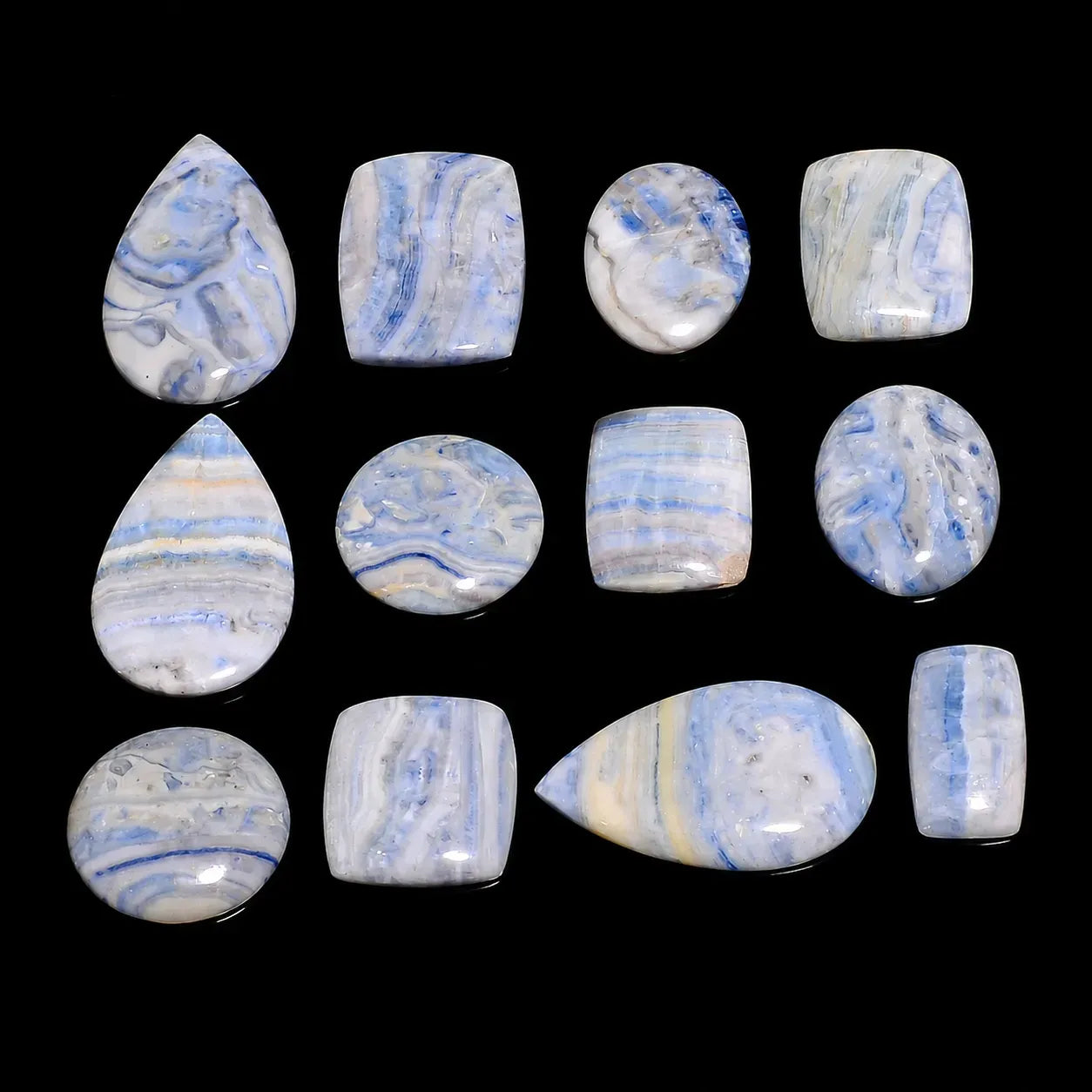 Collection of blue and white marbled stones on a black background