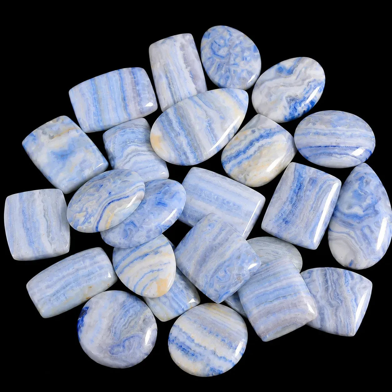 Collection of blue and white marbled stones on a black background