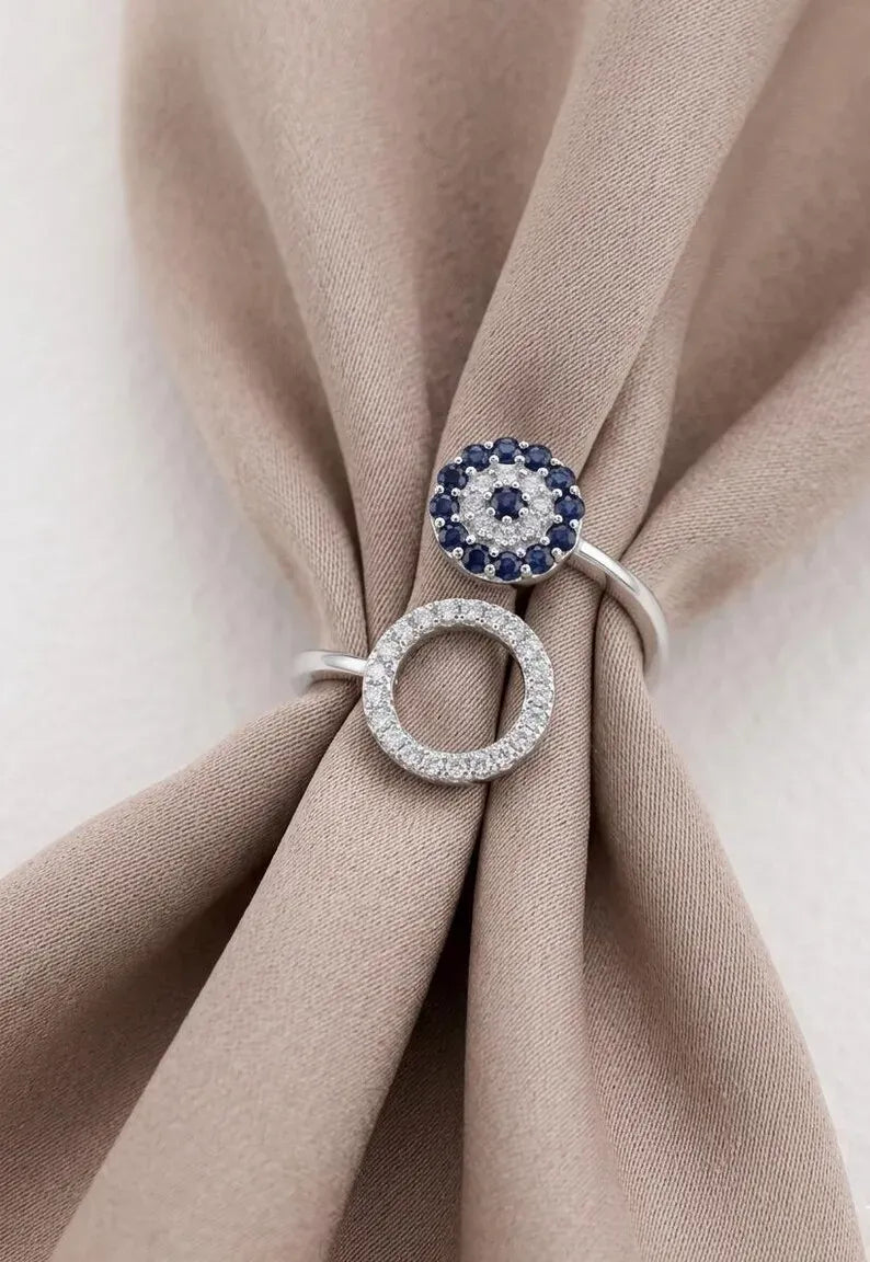 Front view of 925 sterling silver adjustable double circle ring with blue cubic zirconia evil eye