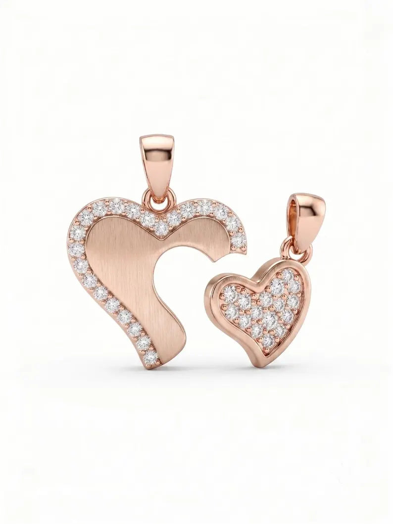Close-up of brushed heart and zircon heart pendants