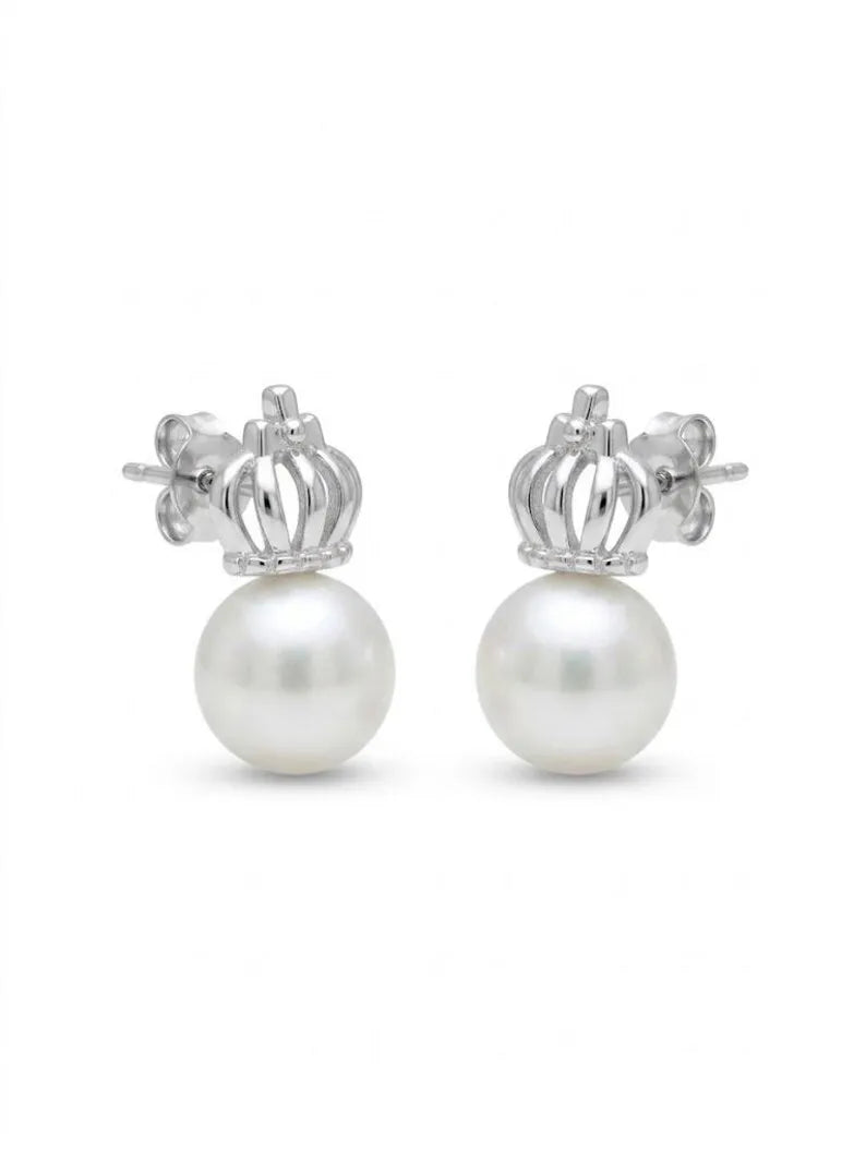 A pair of silver crown stud earrings with a round white pearl hanging from each crown, shown against a plain white background.