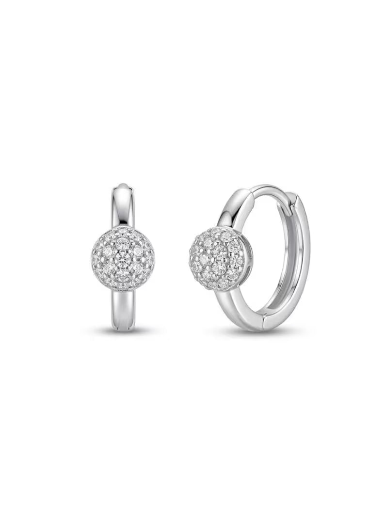 A pair of silver huggie hoop earrings with a pavé-set round crystal ball charm, shown on a clean white background.