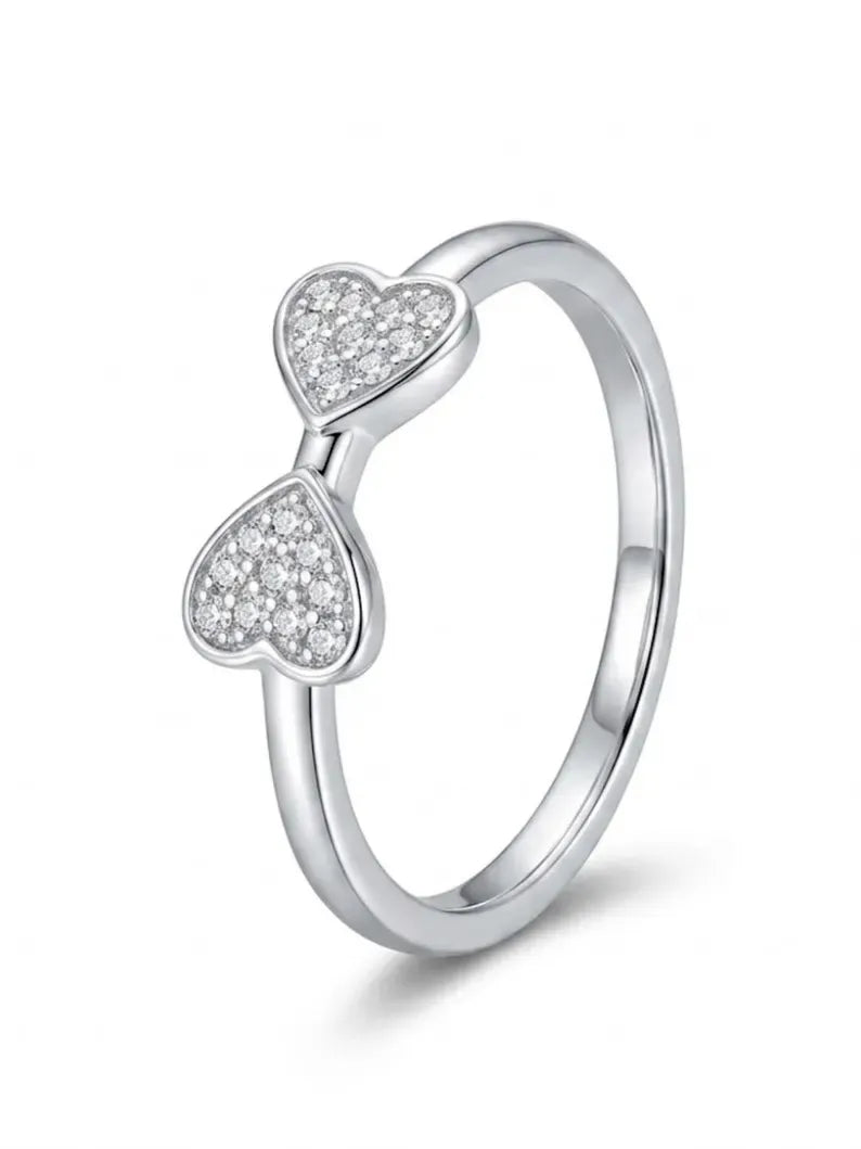 Angled product view showing pave detailing on double heart ring band