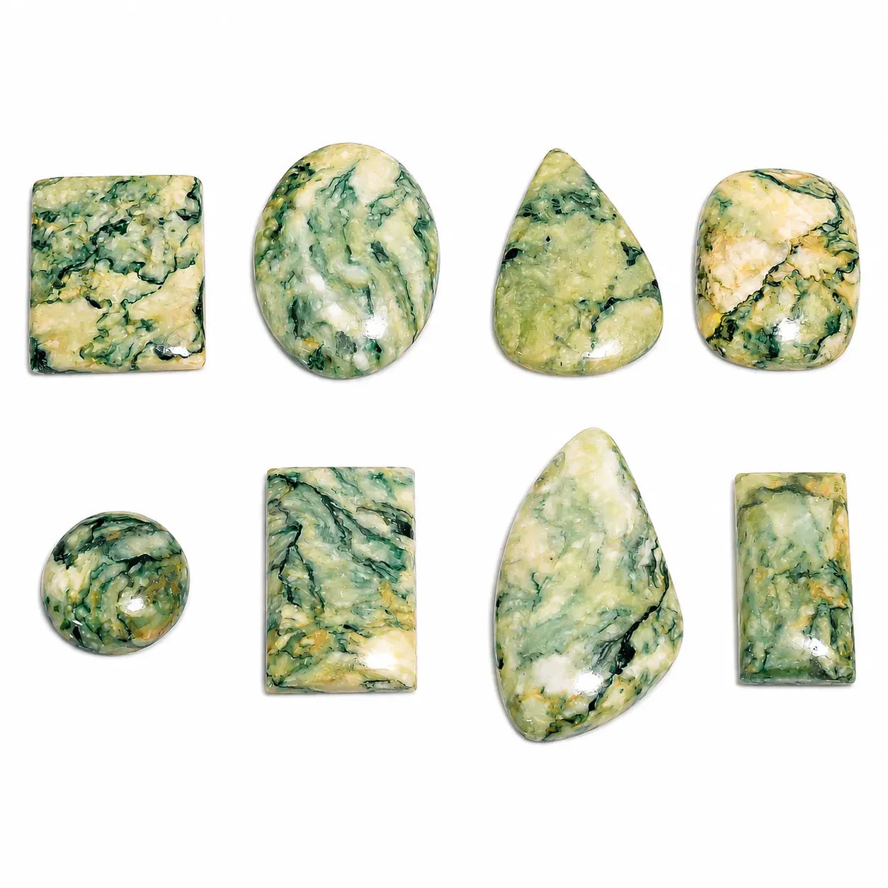 Collection of green and white marbled stones on a white background