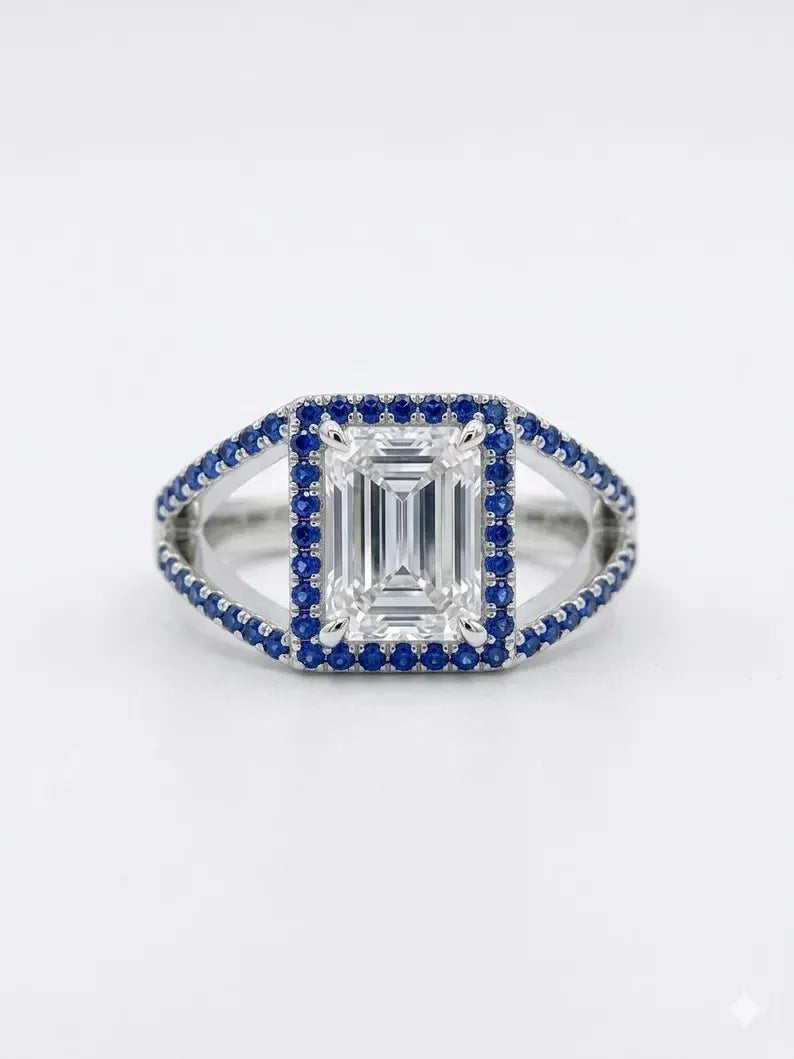Close up of sterling silver emerald cut halo ring with blue cubic zirconia accents
