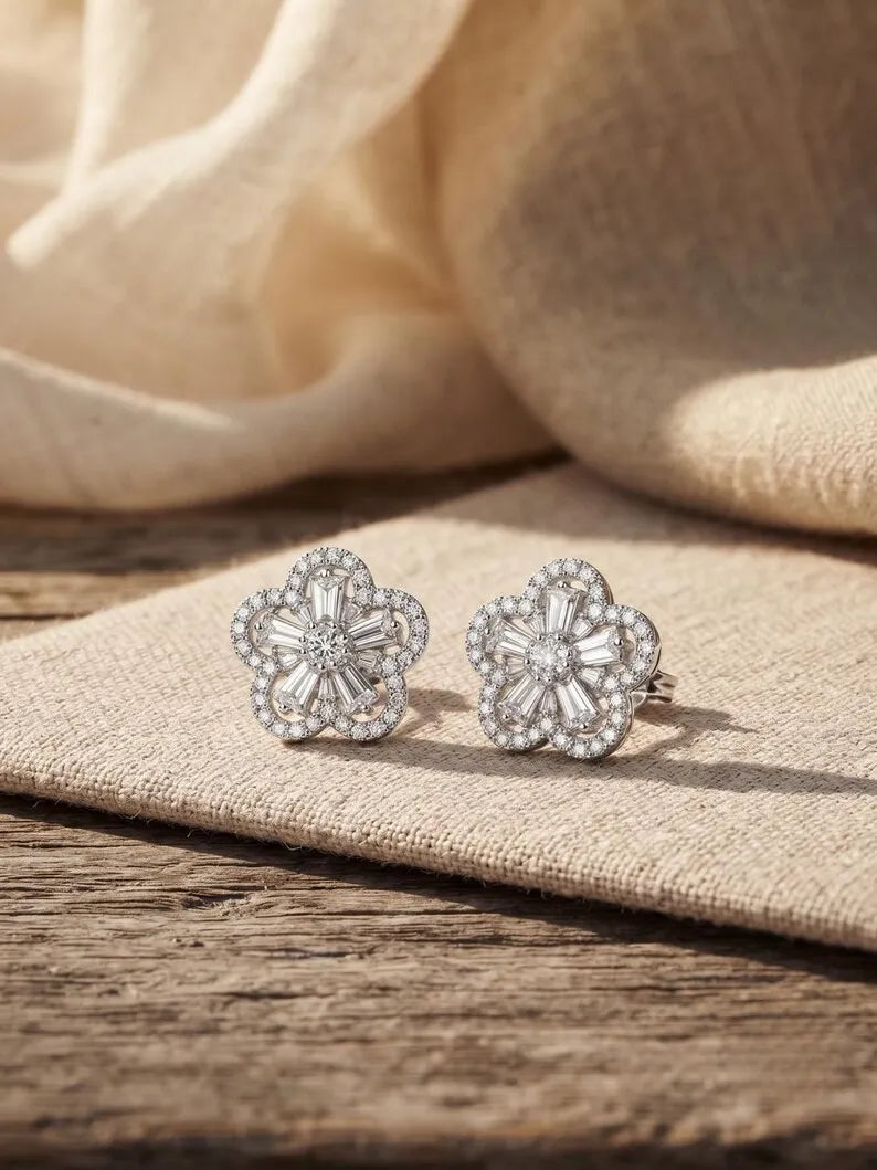 Flower cluster stud earring with baguette halo worn on ear