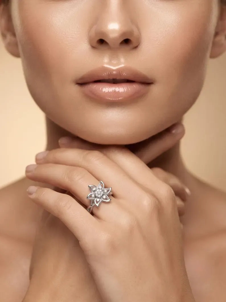 Side angle view of 925 sterling silver flower ring with openwork petals and twisted band