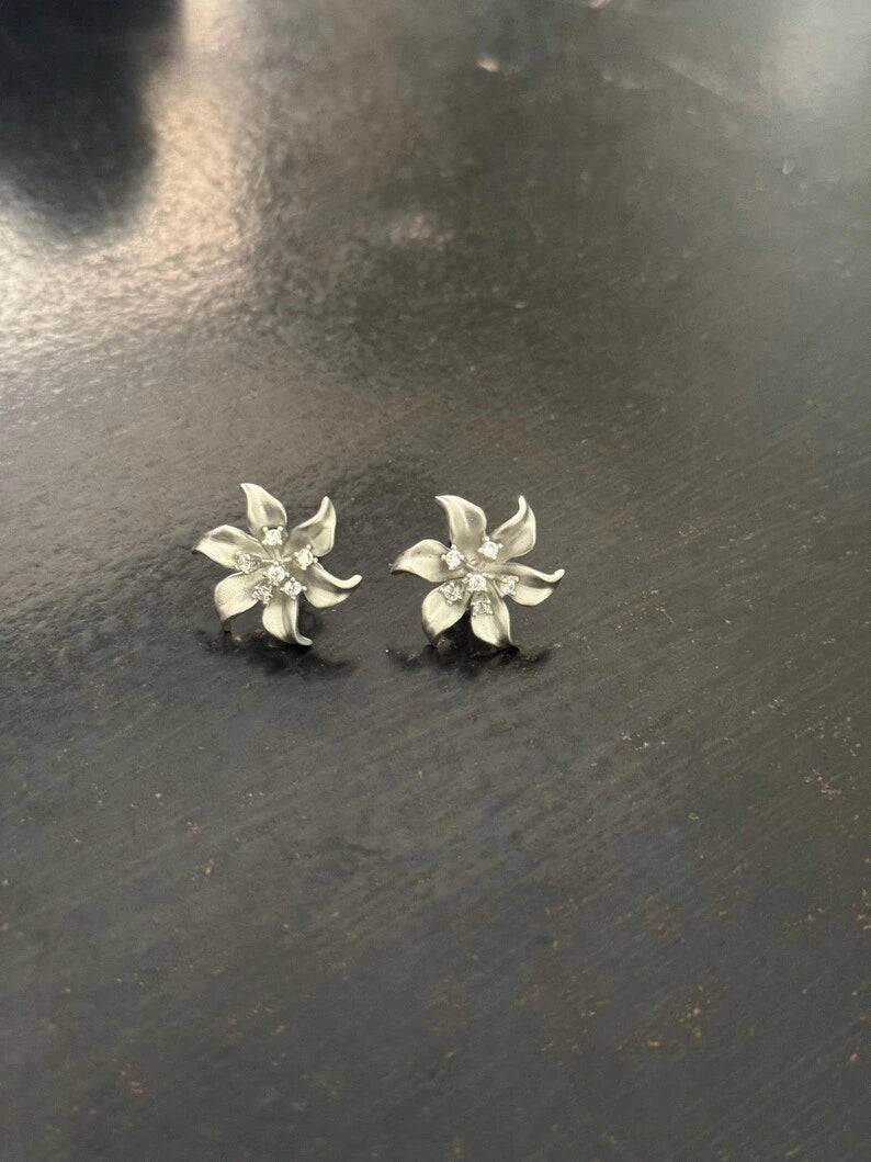 Close-up of cubic zirconia detail on sterling silver flower stud earrings