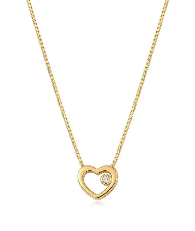 A gold heart pendant necklace with a small clear gemstone set in the center, suspended from a gold box chain against a white background.