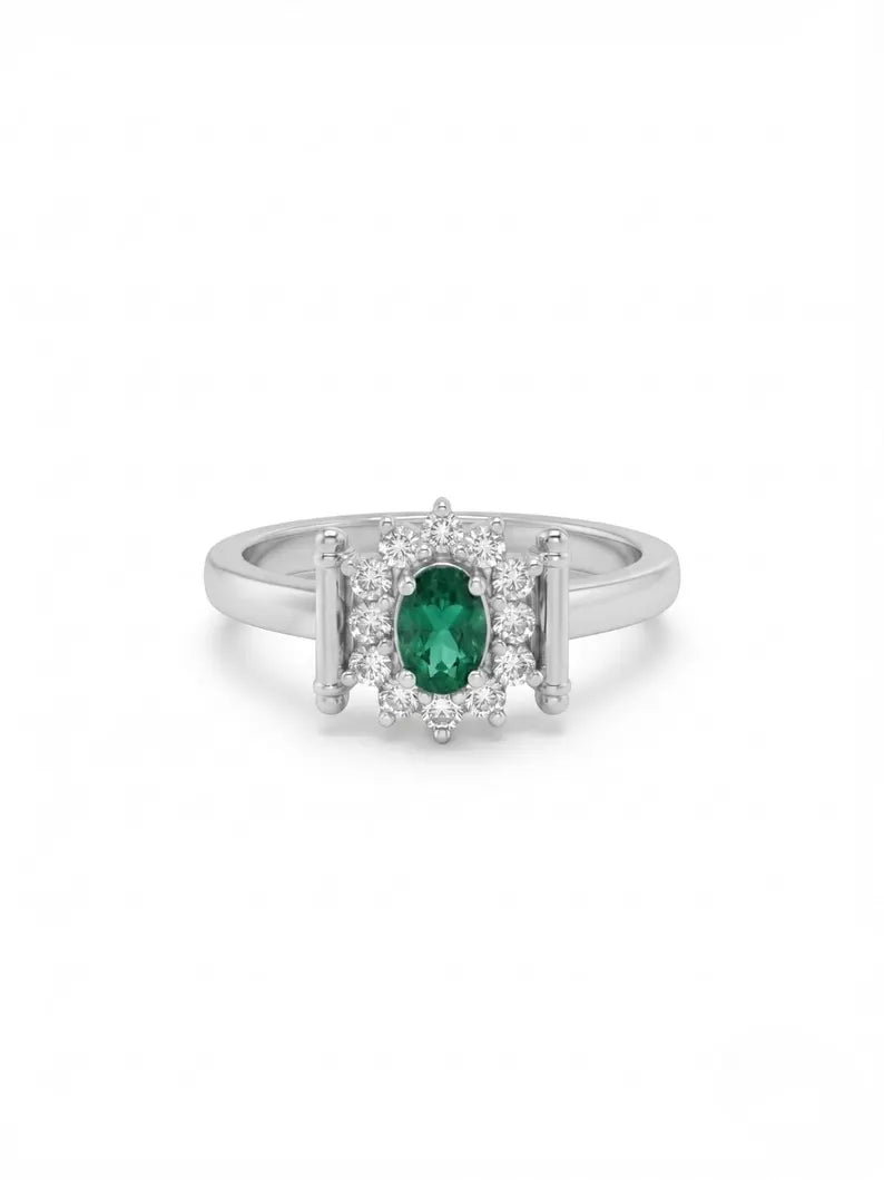 Front-facing shot of oval green gemstone ring with halo and bar accents