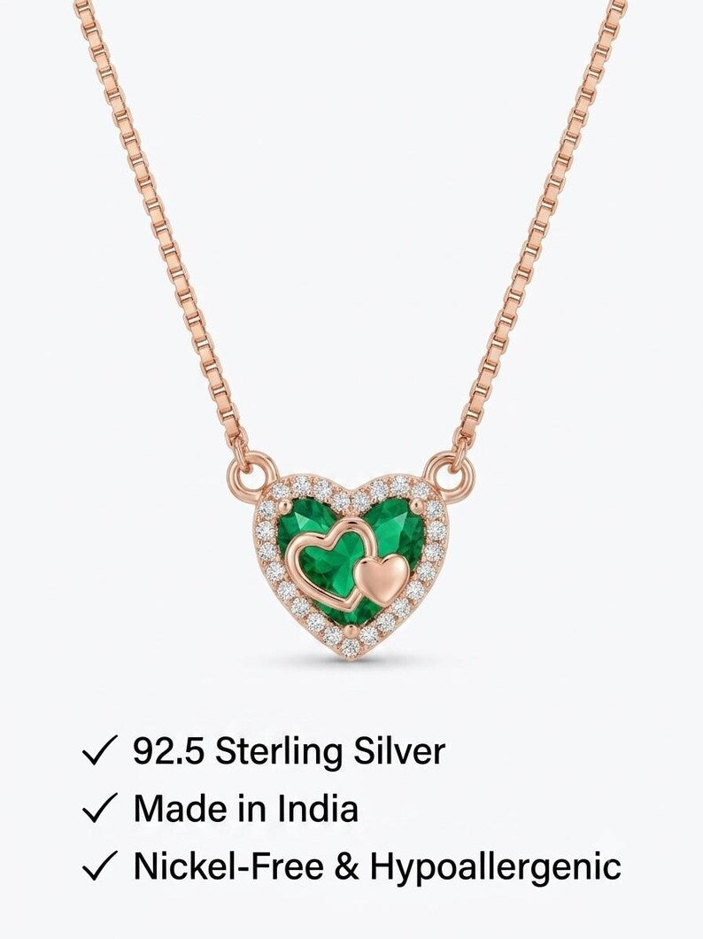 Rose gold green heart necklace on fabric backdrop