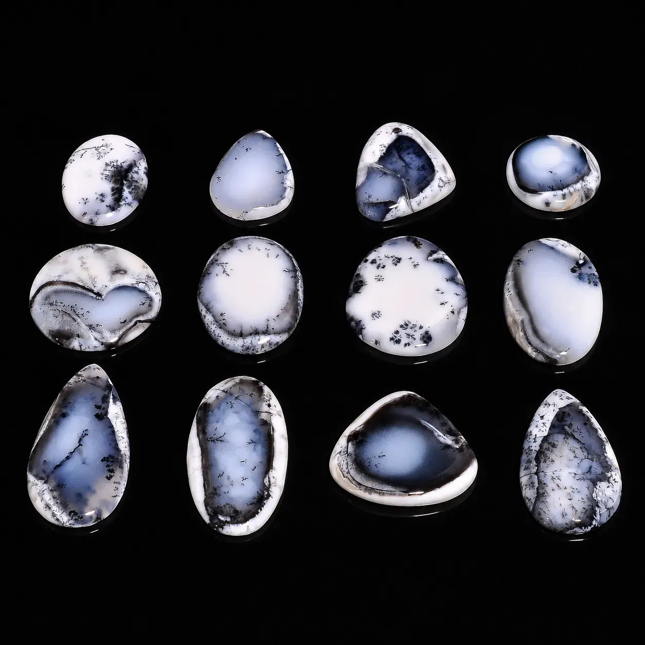 Collection of blue and white marbled stones on a black background