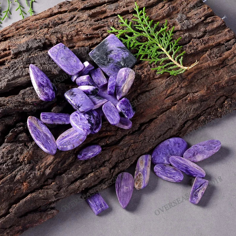 Purple crystals on a wooden surface with greenery