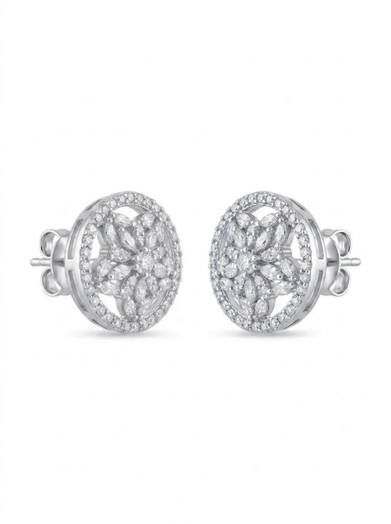 A pair of oval stud earrings with intricate floral pavé detailing in silver-toned metal, set against a plain white background.