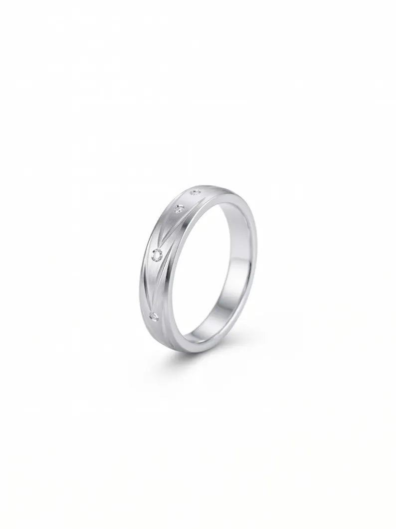 Close up of 925 sterling silver men's ring with brushed finish and clear accent stones