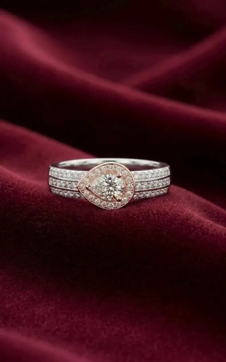 Close up of rose gold and silver pear halo bridal ring with multi row pave cubic zirconia band
