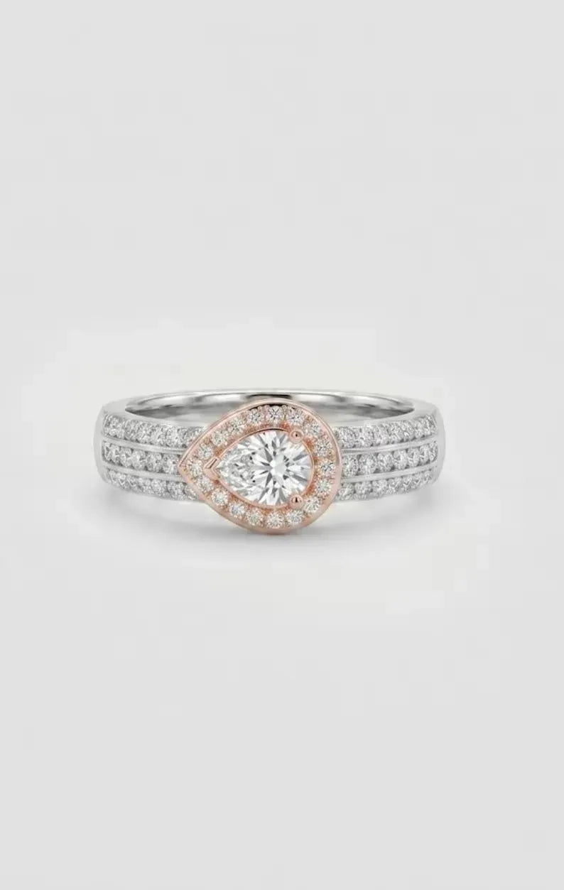 Front view of 925 sterling silver pear cut halo ring with rose gold teardrop setting and pave band