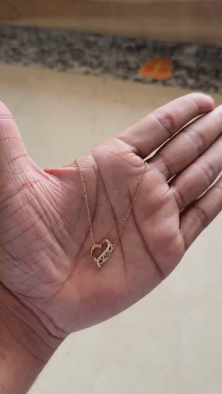Rose gold open heart necklace with LOVE spelled in zircon
