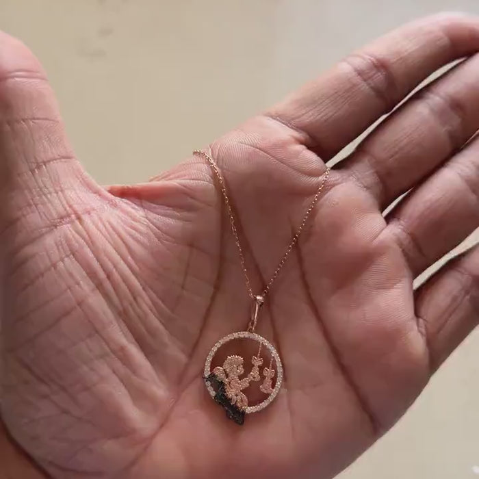 Rose gold angel pendant necklace worn around the neck