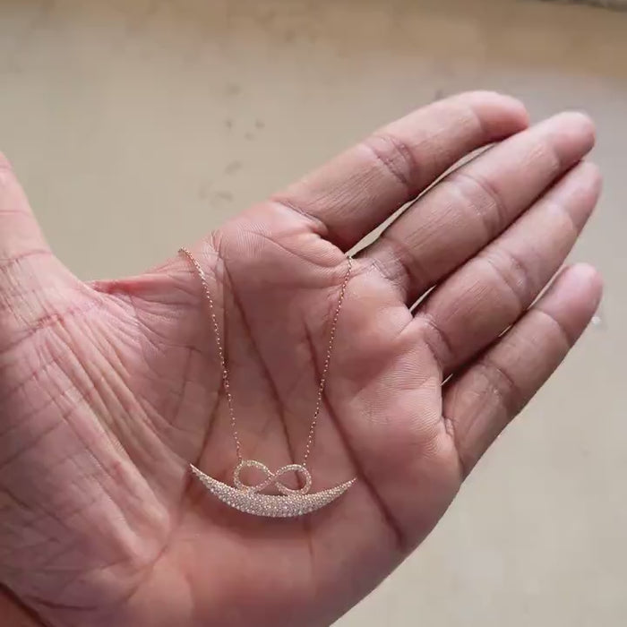 Full view of rose gold infinity smile necklace