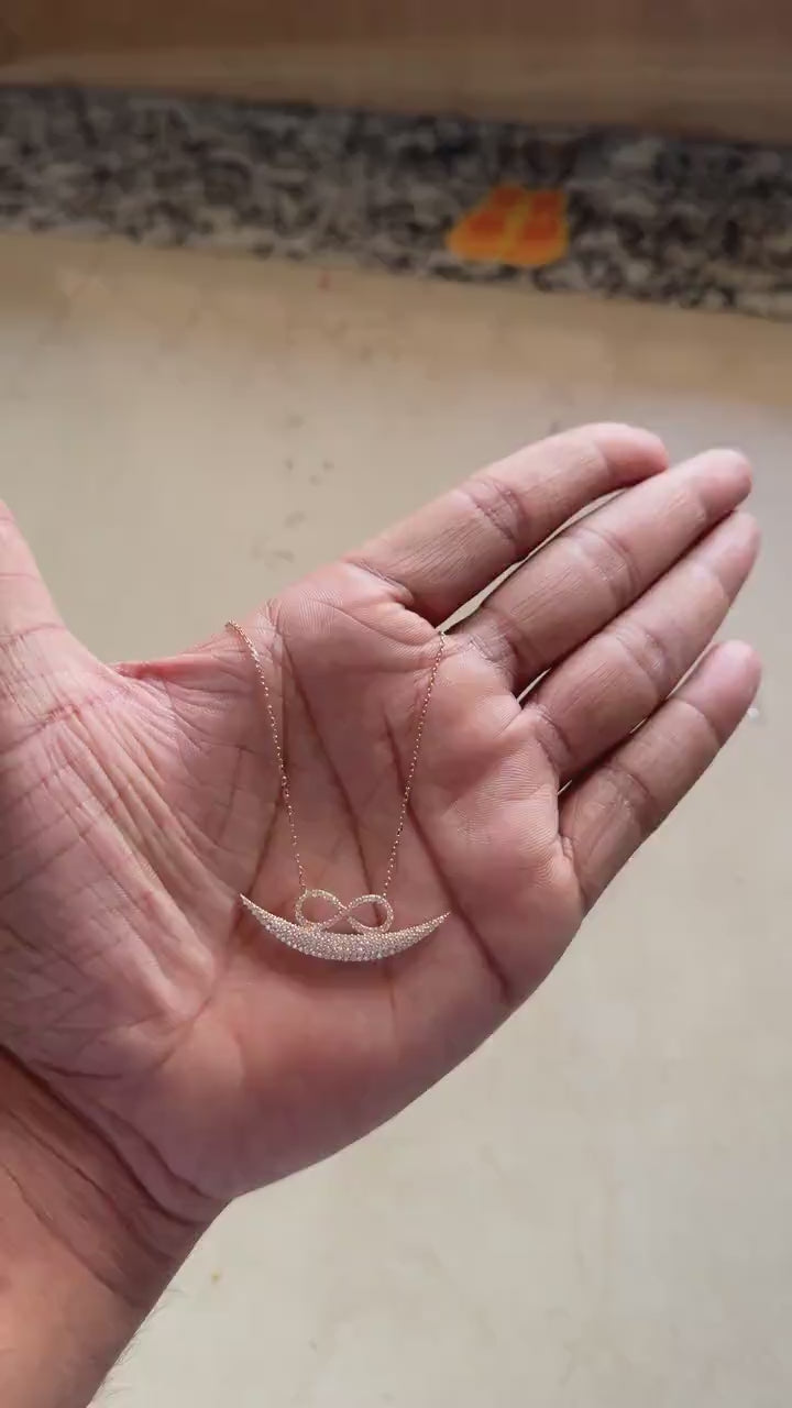 Full view of rose gold infinity smile necklace