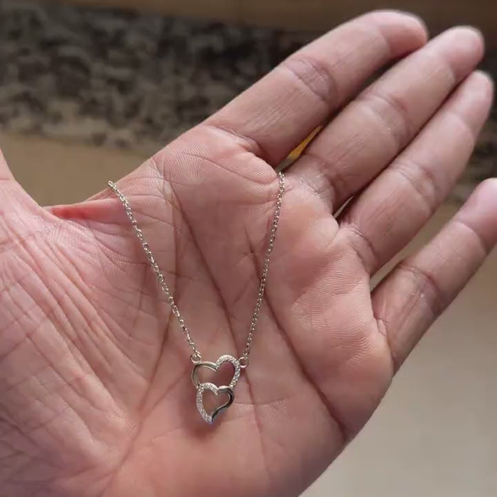 Chain and clasp detail on interlocking heart necklace