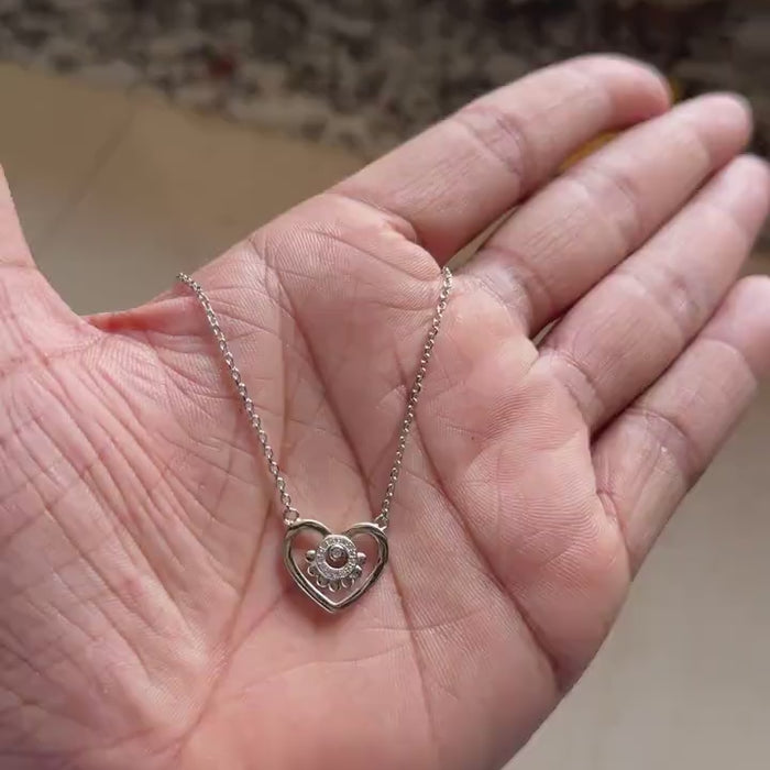 Silver heart necklace with beaded border and zircon cluster center