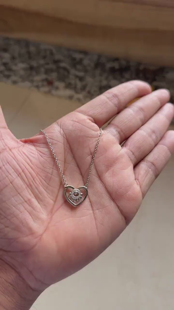 Silver heart necklace with beaded border and zircon cluster center