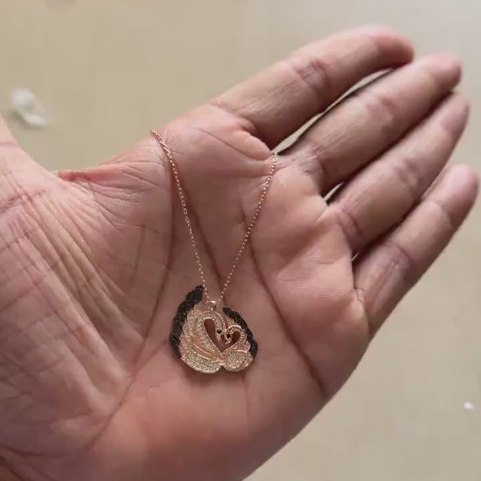 Rose gold swan pendant necklace shaped like a heart