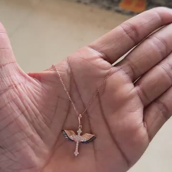 Rose gold winged cross necklace with black and white pavé stones