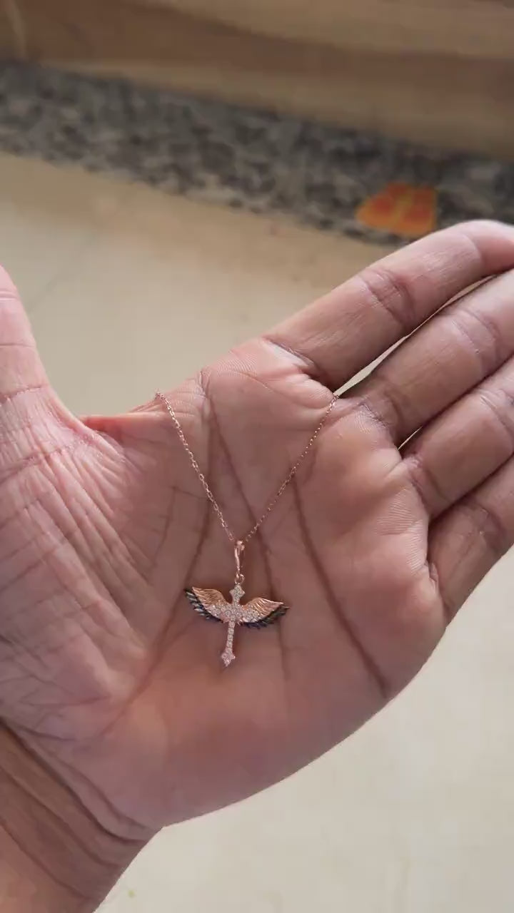 Rose gold winged cross necklace with black and white pavé stones
