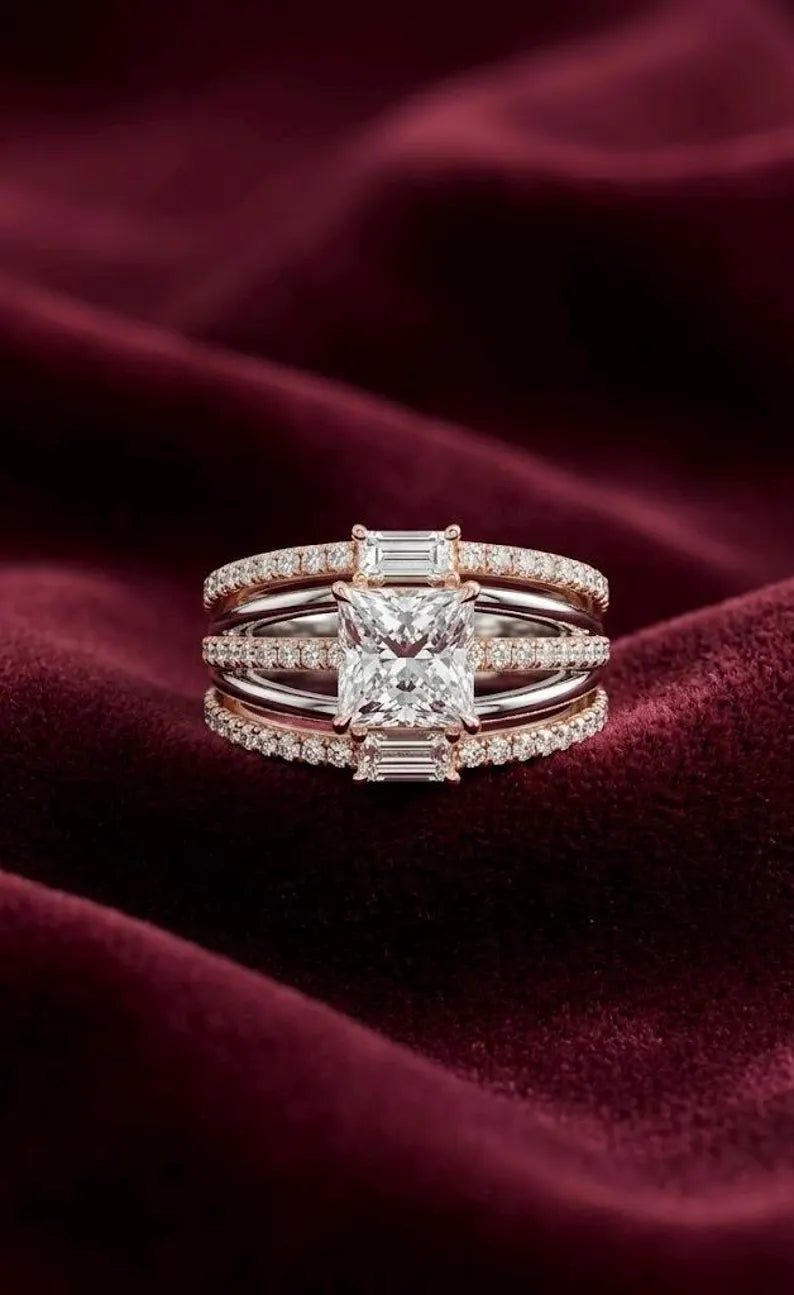 Close up of sterling silver princess cut statement ring with rose gold pave band and baguette side stones