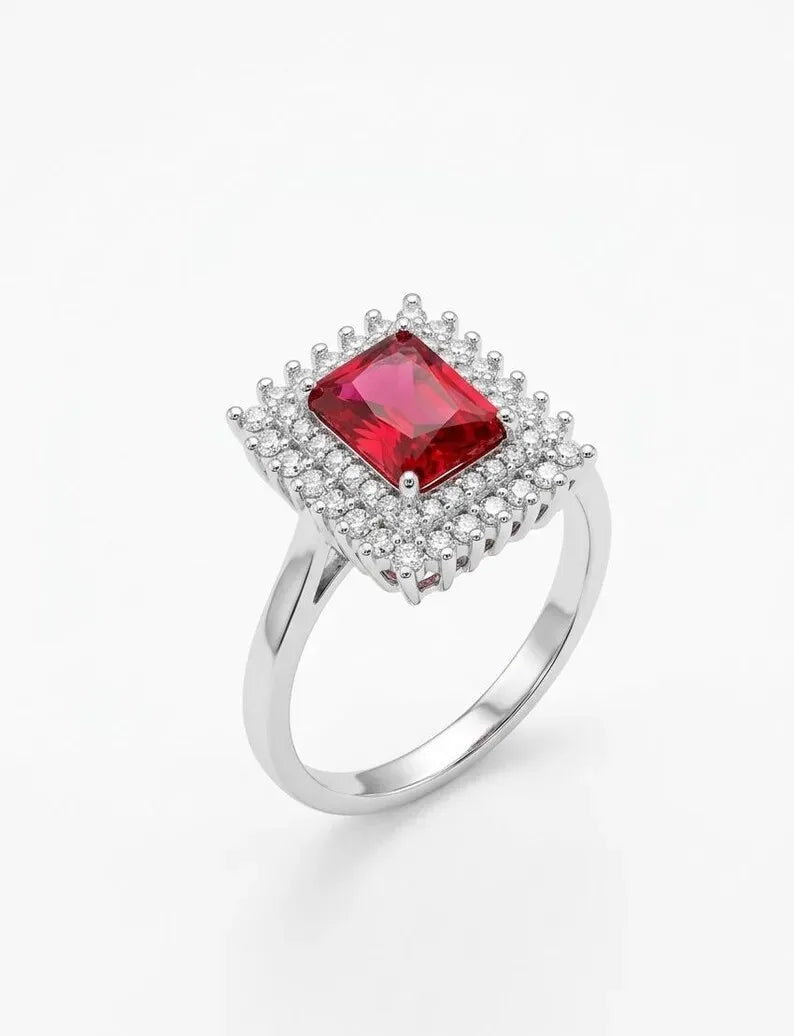Side angle view of sterling silver red square halo ring with emerald cut center stone