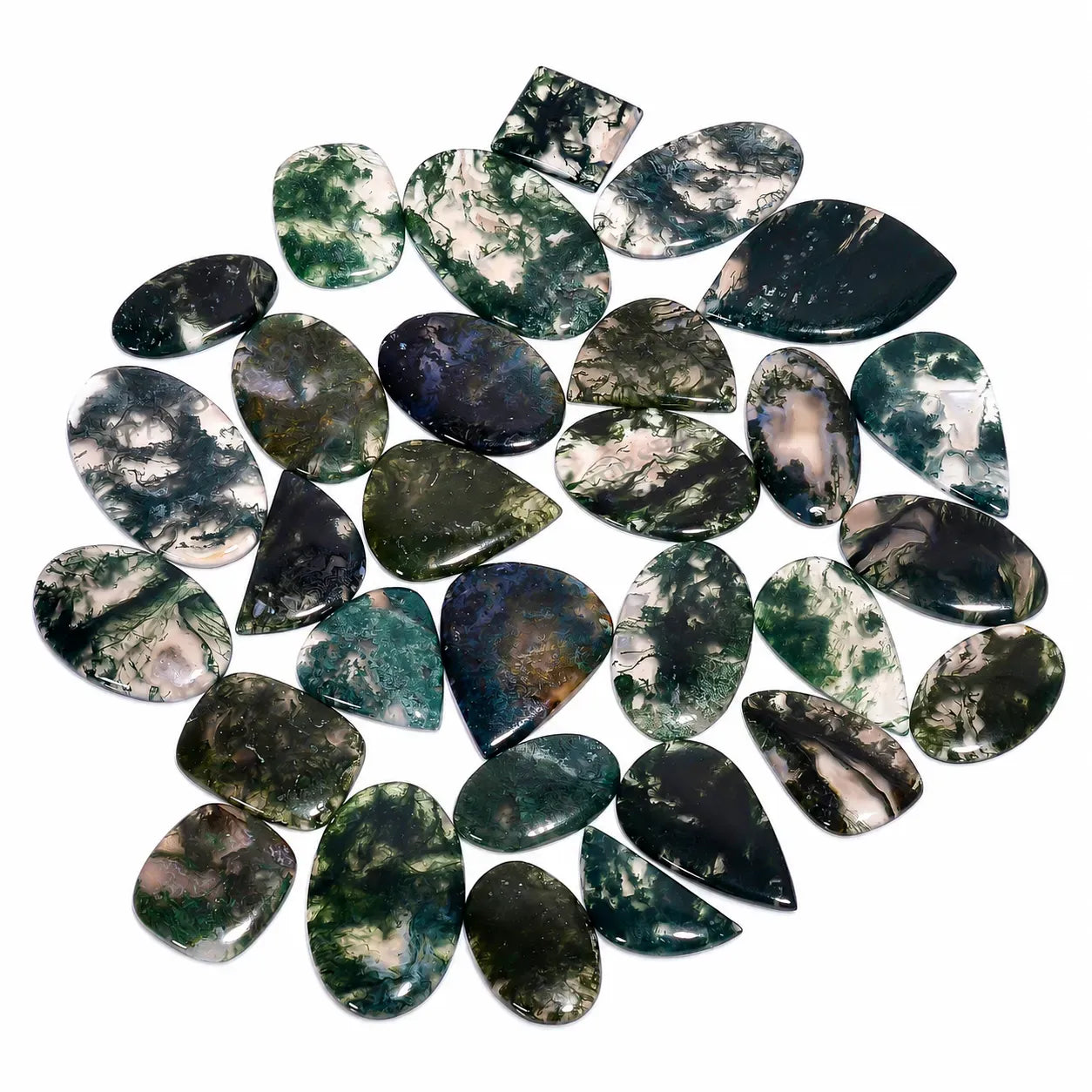 Collection of green and black marbled stones on a white background