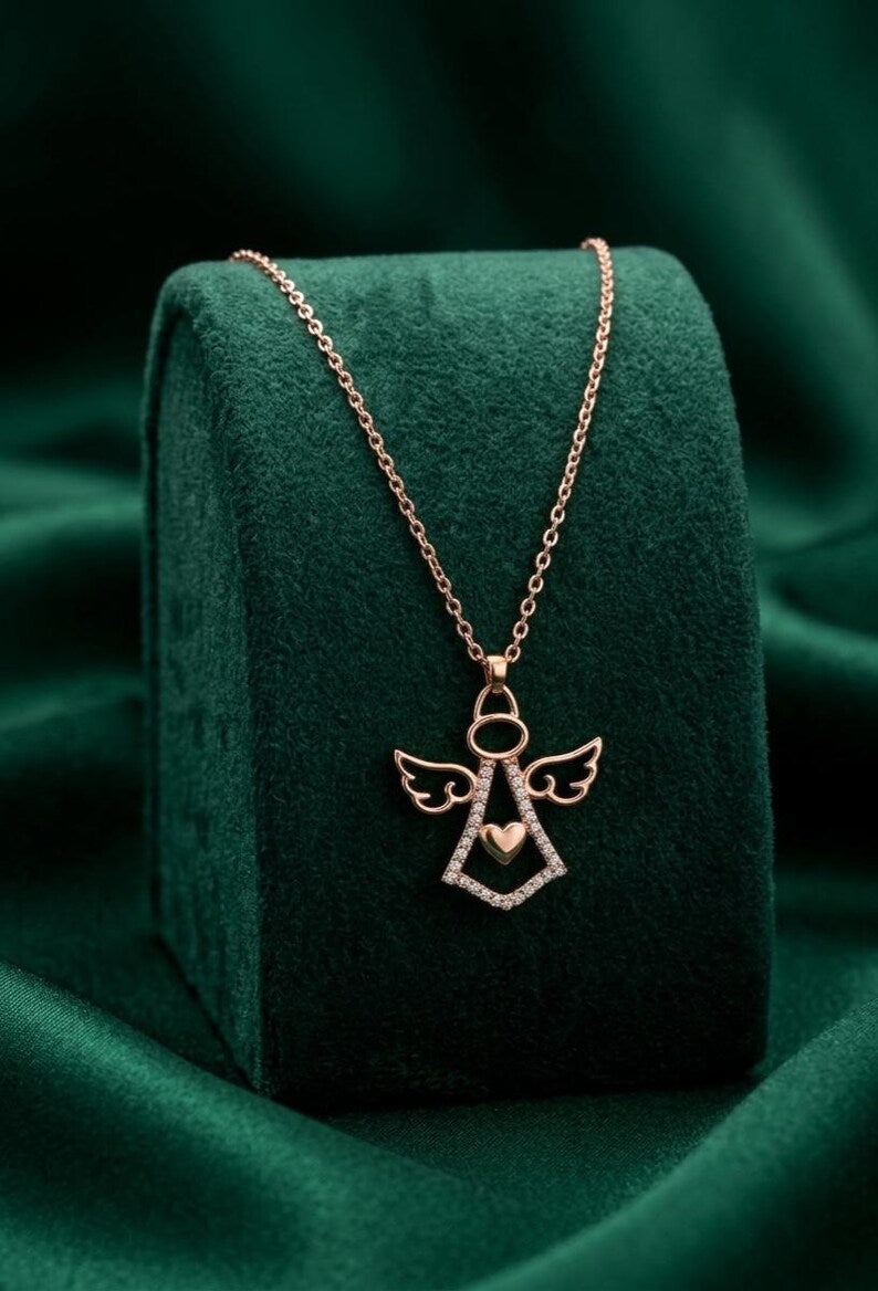 Rose gold angel pendant necklace with heart center detail