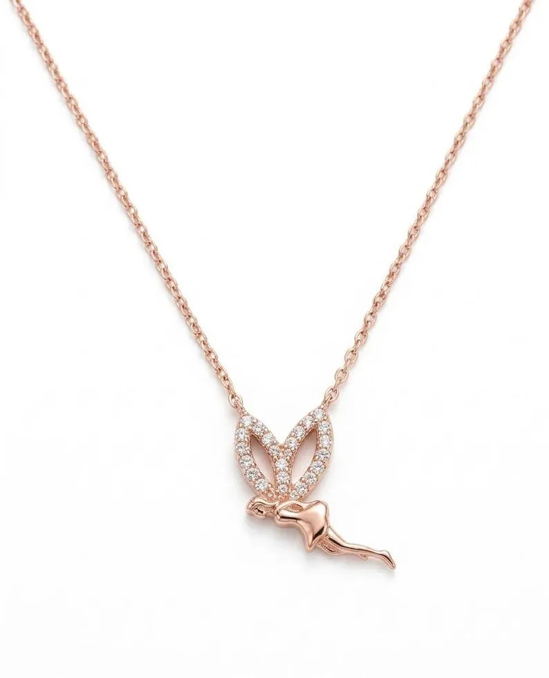 A rose gold necklace featuring a delicate chain and a pendant shaped like a butterfly with a small bird perched on its wings, set with small clear stones, on a plain white background.