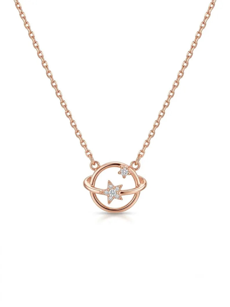 A rose gold necklace featuring a delicate chain and a pendant with a circular ring design and a star-shaped crystal accent, shown on a clean white background.