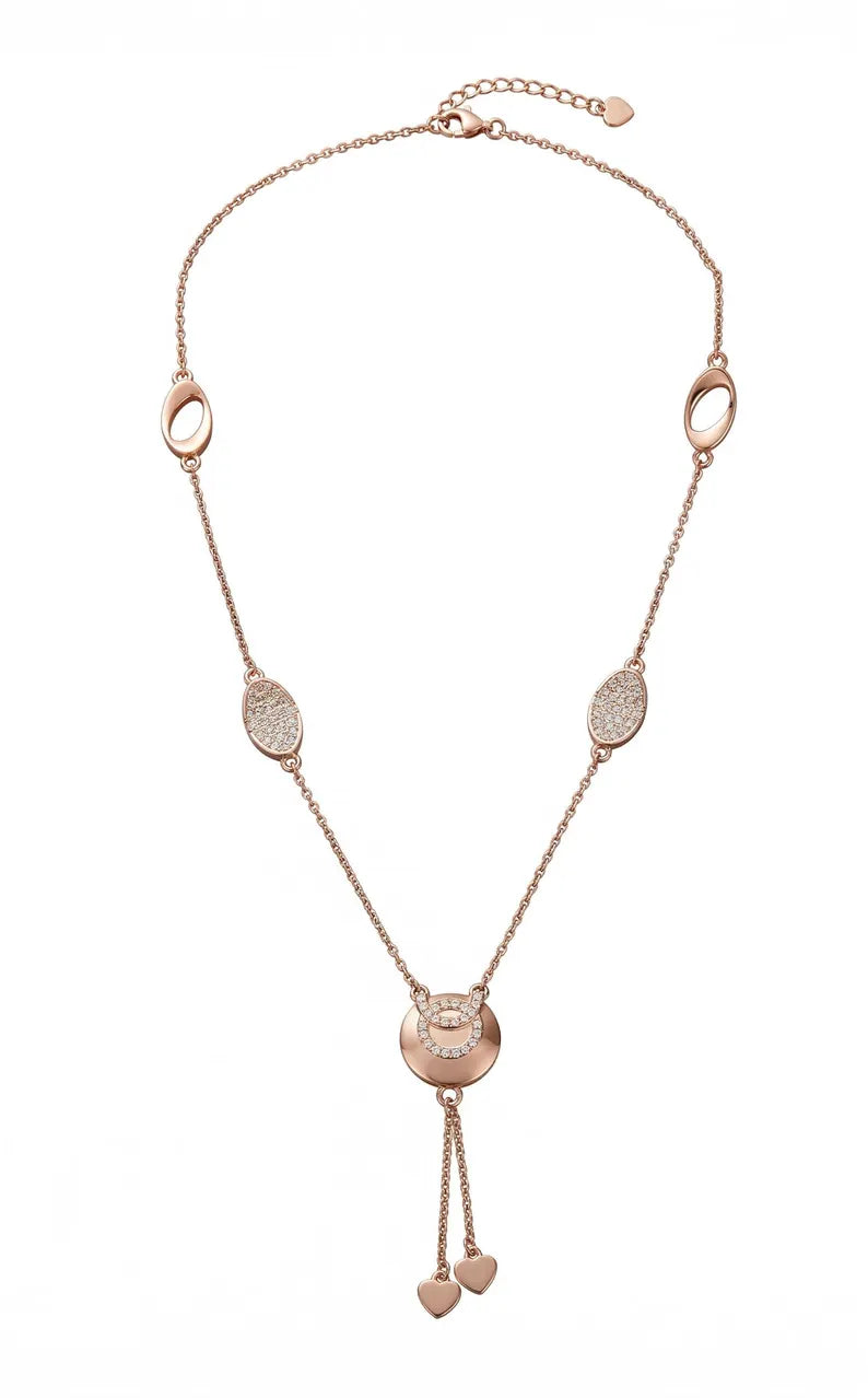 A rose gold heart pendant necklace featuring a delicate chain with oval and textured disc charms, a central round disc, and two dangling heart charms at the bottom, displayed on a clean white background.