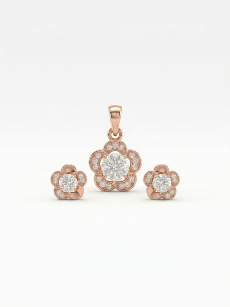 Rose gold jewelry set featuring a central flower-shaped pendant with a round clear center stone and smaller surrounding stones, accompanied by two matching flower stud earrings, shown on a white background.