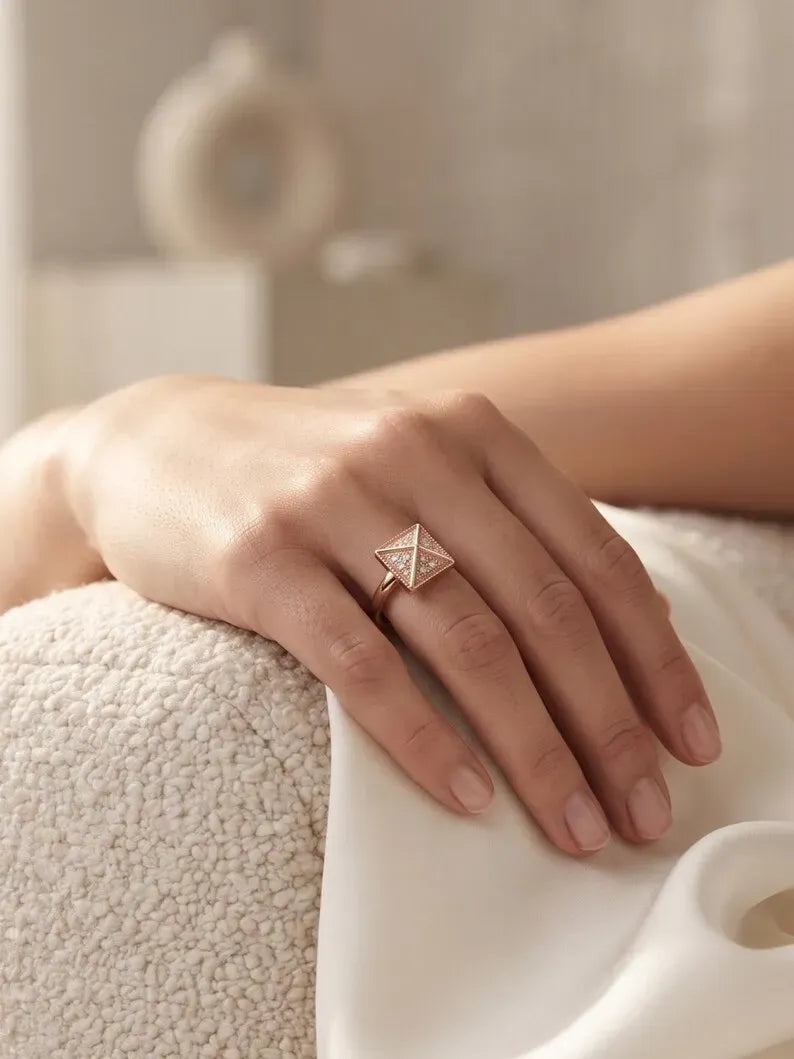 Close up of hand wearing rose gold triangle pattern statement ring